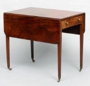 A George III mahogany Pembroke table
The rectangular twin flap top above a frieze drawer and