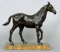 A bronze model of a horse
Naturalistically modelled standing on a marble plinth base.  50 cms wide.