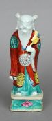 An 18th/19th century Chinese model of an immortal
Modelled in coloured robes holding a fan.  21