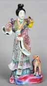 A 19th century Japanese porcelain figurine
Modelled as a young girl in brightly coloured flowing