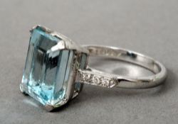 An 18 ct white gold diamond and aquamarine ring
The claw stone emerald cut aquamarine above