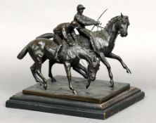 A late 19th/early 20th century bronze group
Formed as two horses with jockeys up, standing on a