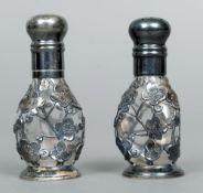 A pair of Chinese silver salt and pepper shakers, each marked Sterling 950
Each dimpled glass body