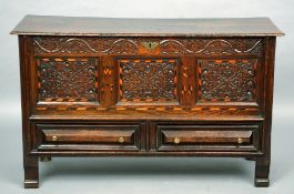 An 18th century oak panelled coffer
The moulded rectangular top above the carved and herringbone