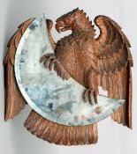 A 19th century Blackforest carved wall mirror
Formed as an eagle perched aside the mirror plate