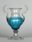 A 19th century Venetian blue and clear glass vase
The urn shaped central body issuing twin scrolling