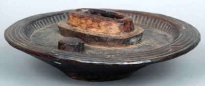 A carved hardwood divination bowl, possibly Aboriginal 
With central recess bordered by simple