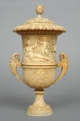 A 19th century carved ivory campana form urn and cover
The removable lid with a pineapple finial