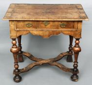 An 18th century walnut lowboy
The quarter veneered and banded rectangular top with moulded edge