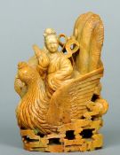 A Chinese carved soapstone figural group
Formed as Guanyin riding a bird through clouds.   14 cms