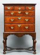 An 18th century and later walnut chest on stand
The moulded rectangular top above an arrangement