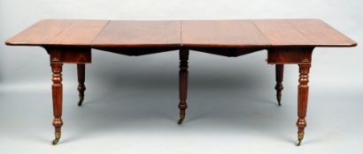 An early 19th century mahogany concertina action extending dining table
The hinged rectangular top