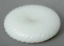 A mutton fat jade disk
Of ribbed design with a central aperture.  4.5 cms diameter.   CONDITION
