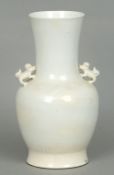 A Chinese porcelain white glaze twin handled vase
Of baluster form, the handles formed as shi-shi,