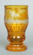 A 19th century Bohemian amber glass goblet
Etched with a continuous scene of deer amongst woodland.