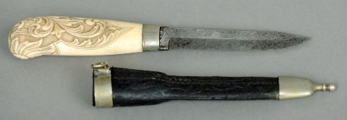 A 19th century Continental ivory handled dagger
With carved scrolling floral decoration, housed in a