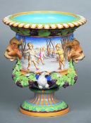 A large Victorian Minton urn
With twin mask handles flanking scenes of playing children, above