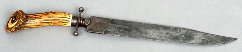 A 19th century bowie knife
With an antler handle.  The florally etched blade 48 cms long.