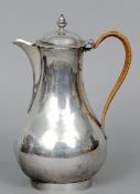 A George III silver coffee pot, hallmarked London 1766, maker's mark of JJ
The domed hinged lid