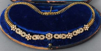 A Victorian unmarked gold seed pearl mounted necklace
Centrally set with seed pearl mounted