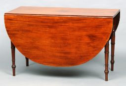 A 19th century mahogany drop leaf table
The oval twin flap top above a plain frieze, standing on