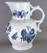 A large blue and white mask jug
The leaf moulded body with double C-scroll handle and decorated with