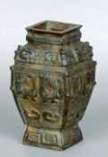 An archaistic style Chinese bronze vase
The bulbous square section body decorated with scrolls and