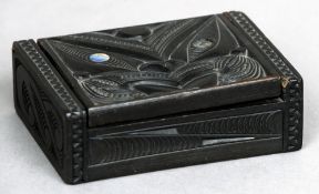 A mother-of-pearl inset carved wooden box, possibly Maori
The rectangular body with a removable lid.