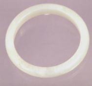 A celadon green jade bangle
Of typical form.  8.25 cms diameter.    CONDITION REPORTS:  Overall