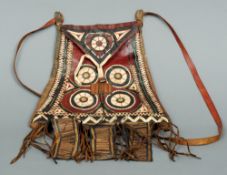 A Native American leather medicine bag
The loop handle above the main body with geometric
