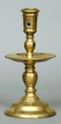 A 17th century Dutch brass public house candlestick
The tapering sconce above the bulbous stem