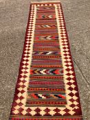 A Kilim wool runner
The central field with geometric bands within a geometric border.  180 x 80 cms.