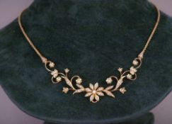 An Edwardian 15 ct gold seed pearl necklace
The front formed as scrolling foliage inset throughout