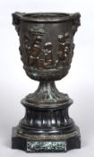 A 19th century bronze urn 
Decorated with putti in various pursuits beneath Bacchic masks over a
