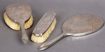 An early 20th century Chinese silver three piece dressing table set
Comprising: two brushes and a