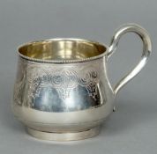 A 19th century Russian silver mug
The beaded rim above the squat body with engraved decoration and