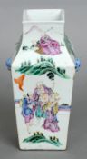 A 19th century Chinese vase
Of tapering square section form with twin dog-of-fo head and loop