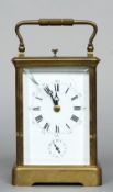 A 19th century quarter striking carriage alarm clock
The lacquered brass case with a white enamelled