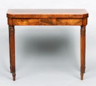 An early 19th century rosewood card table
The line inlaid canted rectangular hinged top enclosing