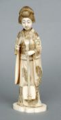 A Japanese carved ivory okimono
Formed as a female musician, standing on a plinth base, the