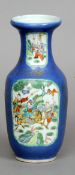 A Chinese porcelain vase
Decorated with warring figures on horseback vignettes, on a blue ground