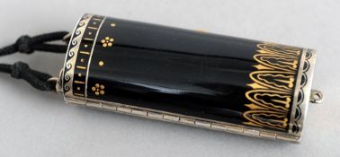 An Art Deco enamel decorated compact
The black ground with yellow metal inlays.  8.5 cms high.