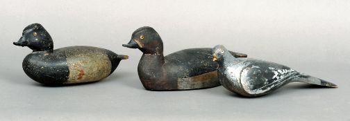 Two early 20th century carved wooden decoy ducks and a carved wooden decoy pigeon
Each