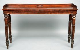 A William IV mahogany serving table
The carved three quarter galleried top above a plain frieze,