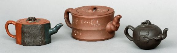 Three Chinese Yixing teapots
One with bark effect decoration.  The largest 19 cms wide.  (3)