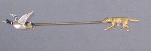 A 15 ct gold pearl mounted and enamelled stick pin
Modelled as a gun dog pursuing a mallard in