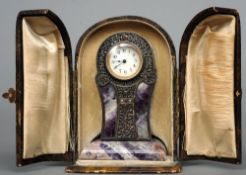 A late 19th century Continental silver mounted amethyst desk clock
Of shaped balloon form, the white