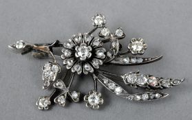 An unmarked white gold diamond set brooch
Of floral spray form.  4.5 cms wide.   CONDITION REPORTS: