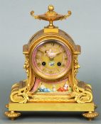 A 19th century gilt bronze mantle clock
Mounted with painted porcelain panels, the circular dial