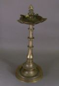A 19th century Eastern bronze oil lamp
The finial mounted reservoir above the knop mounted stem,